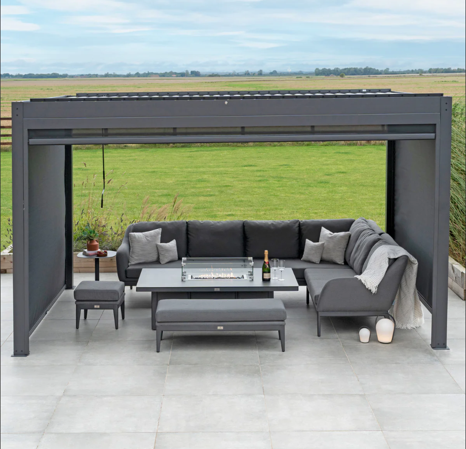 Manual louvered pergola with drop-side blinds over outdoor furniture