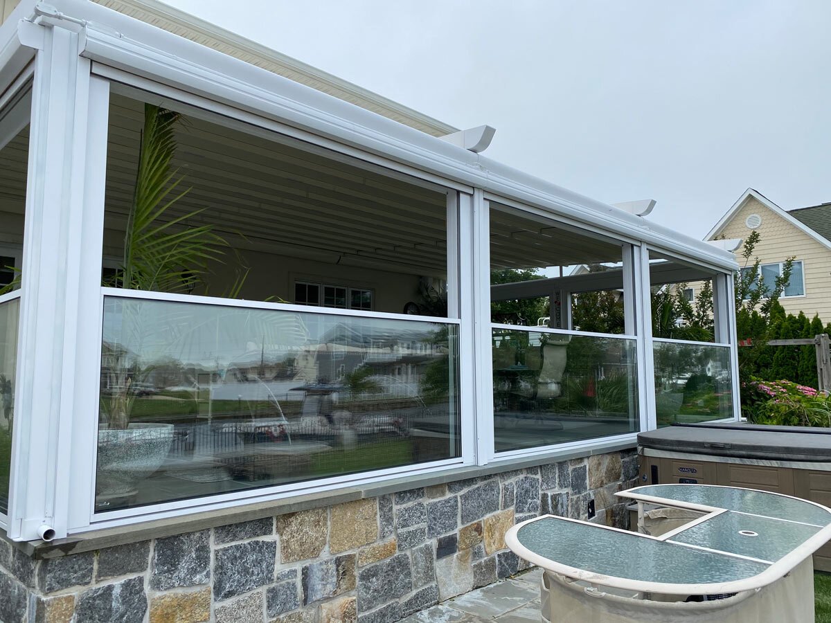 Outdoor shade integrated with a glass wall system