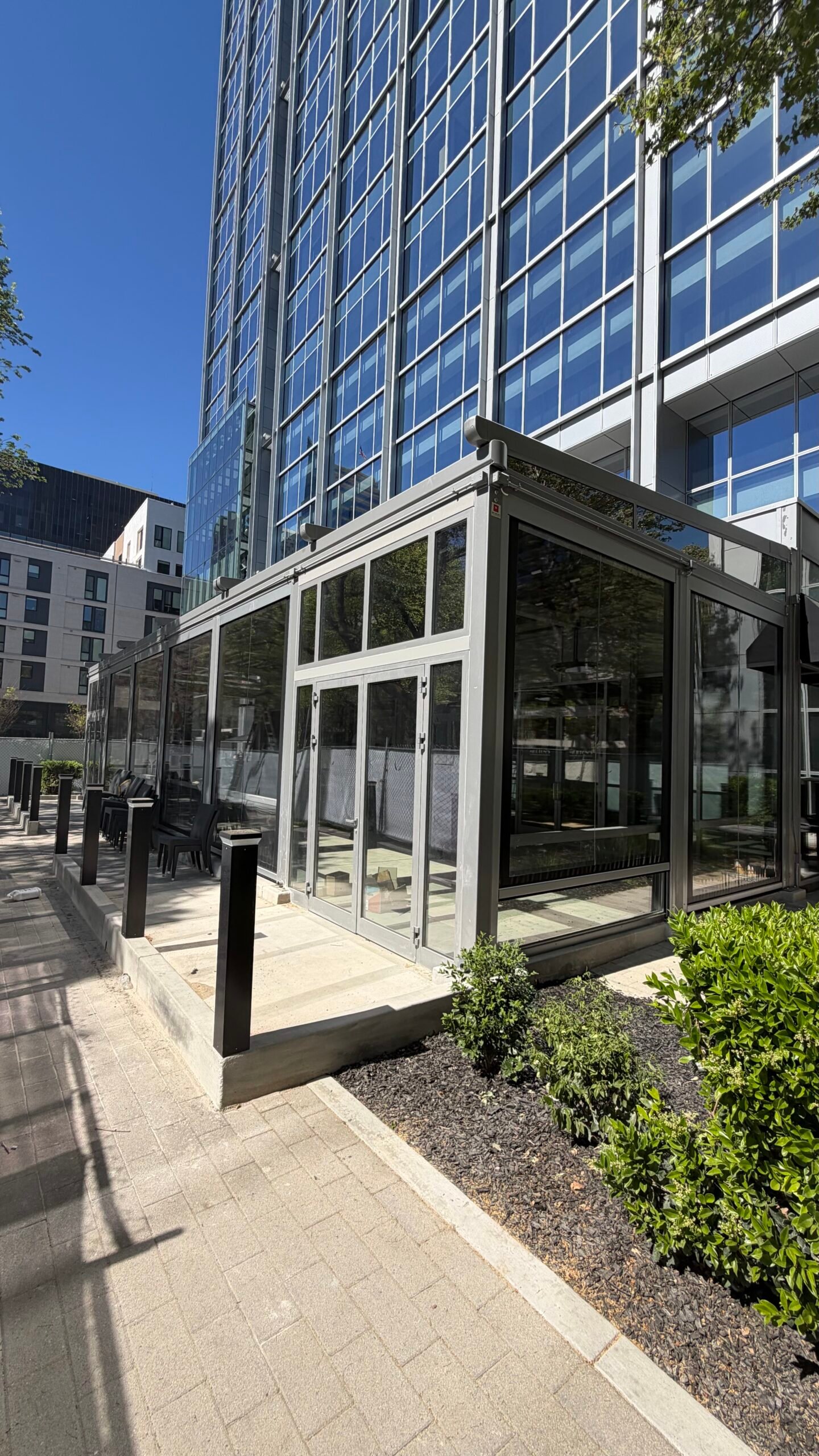 Glass patio enclosure for a steakhouse