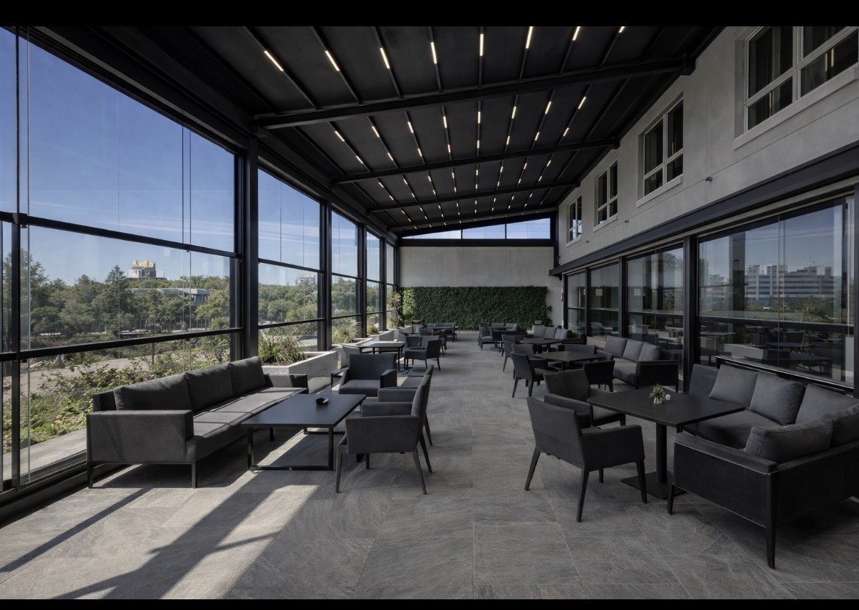 Louvered pergola with glass patio enclosure by String Lights Outdoor