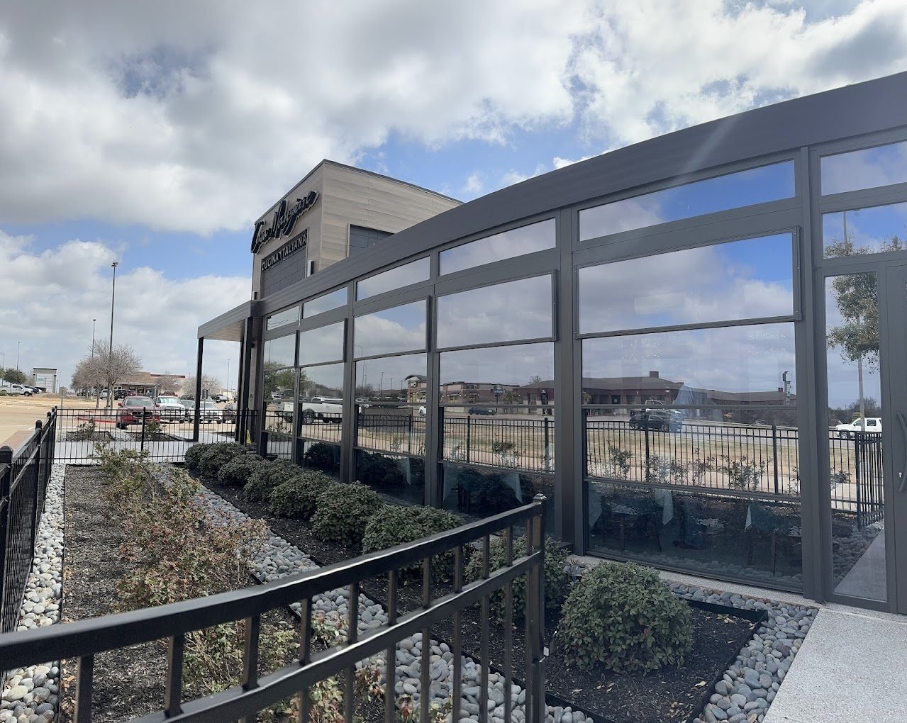 Fixed aluminum pergola with guillotine glass walls at Casa Mangiare Cucina Italiana, College Station, Texas