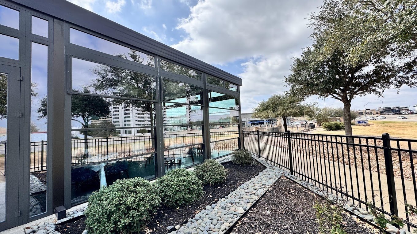 Motorized guillotine glass walls on a restaurant patio in College Station, Texas