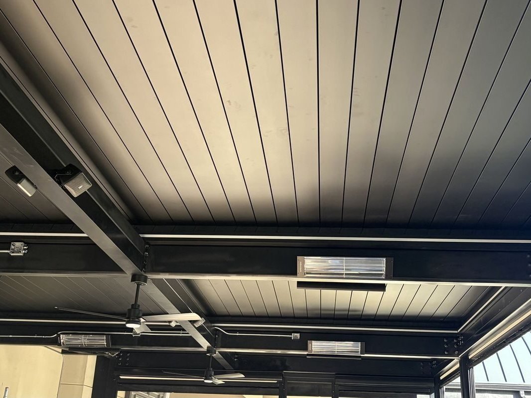 Ceiling-mounted infrared heaters and fan under the louvered roof