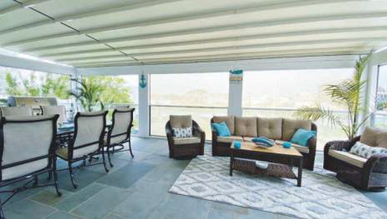 Outdoor living room with guillotine glass and shades