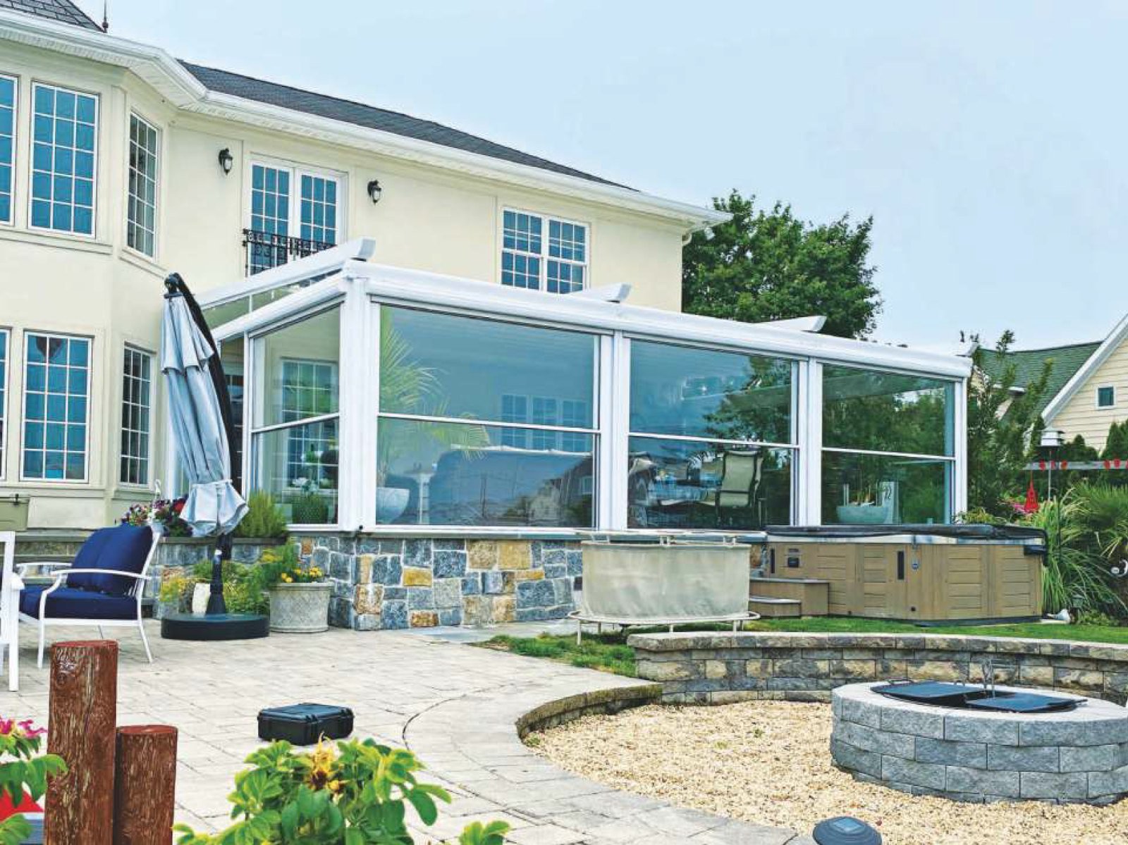 Residential patio enclosure with motorized guillotine glass panels