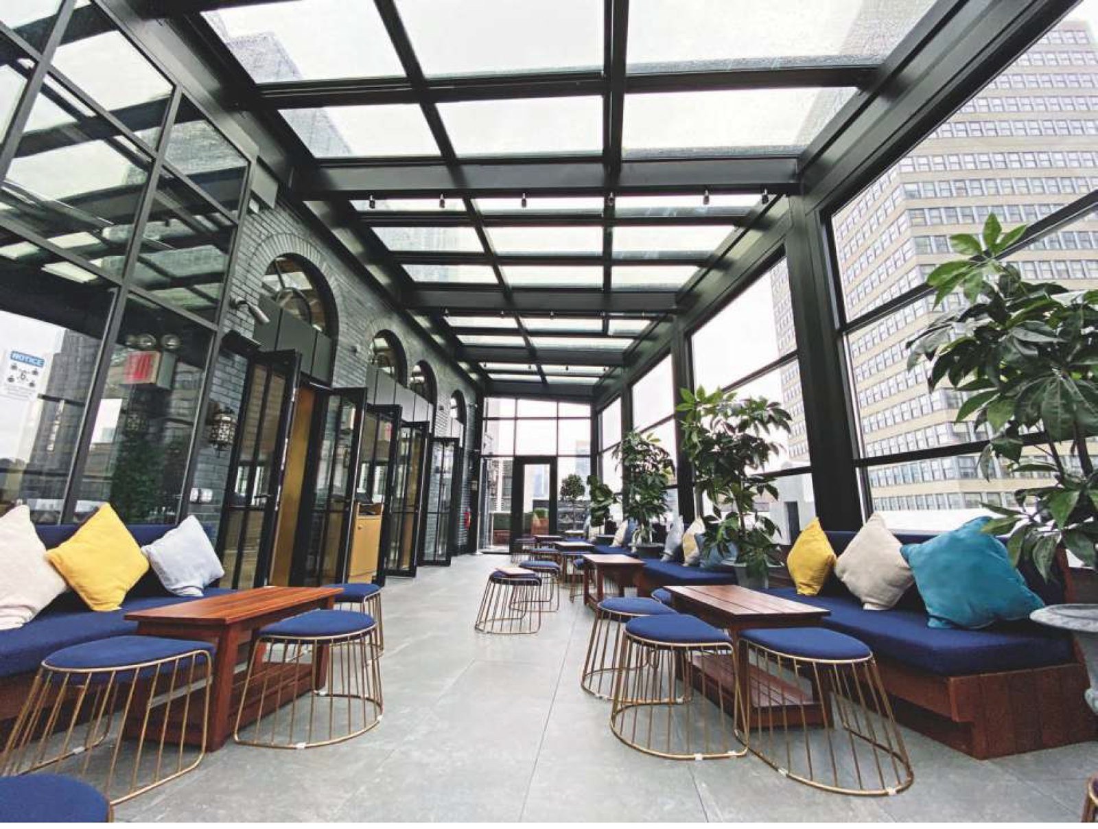 Rooftop lounge enclosed with guillotine glass walls